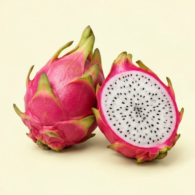 A bright pink dragon fruit cut to show its white, black-speckled flesh